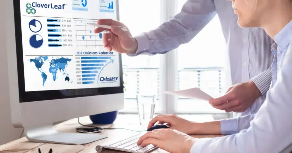 two people looking at a Odyssey dashboard showing charts and graphs on a computer screen