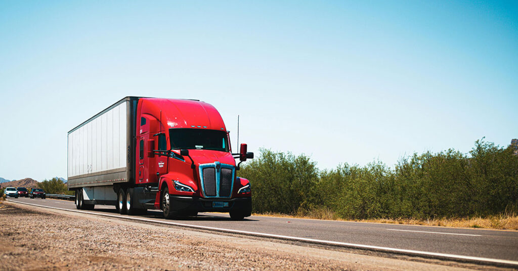 semi truck and trailer driving down the highway