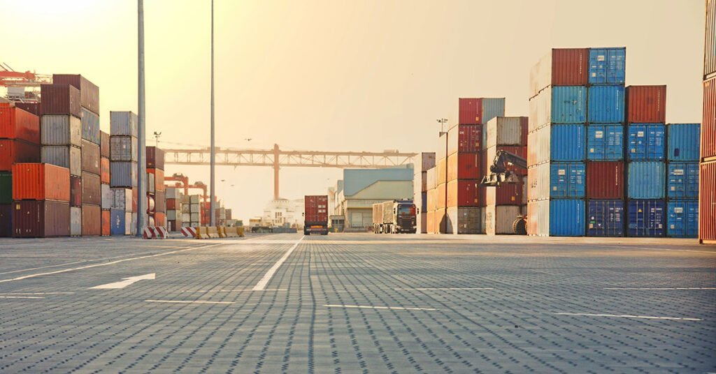 shipping containers stacked at a port